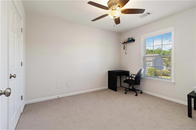 unfurnished office with carpet, baseboards, and ceiling fan