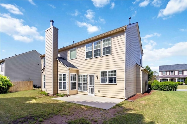 back of house with a chimney and a patio area