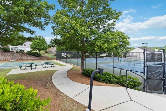 view of tennis court featuring fence