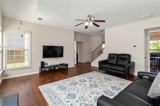 living room with ceiling fan, stairs, wood finished floors, and baseboards