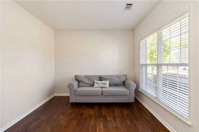 living area featuring dark wood-type flooring and baseboards