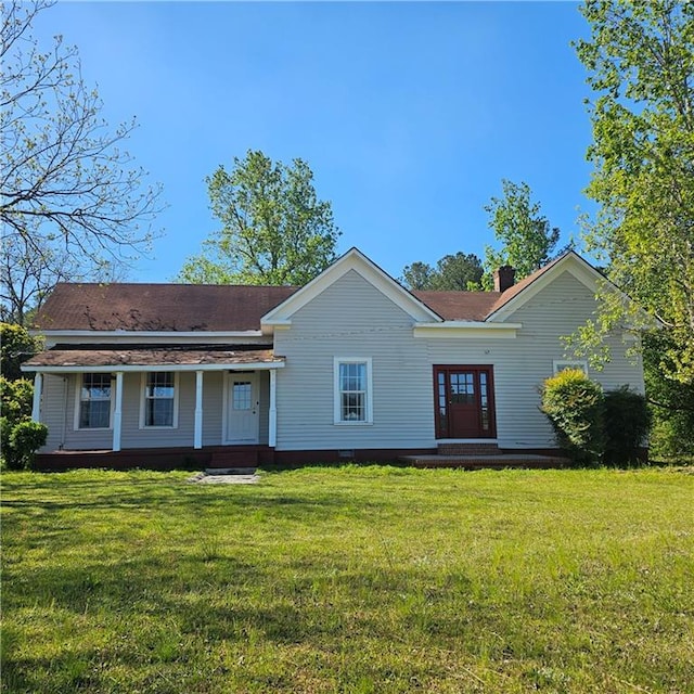 ranch-style house featuring a front lawn and a chimney