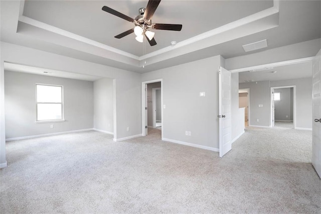 113 Canal St, Hampton, GA 30228 - spare room featuring a raised ceiling, a ceiling fan, light colored carpet, and baseboards