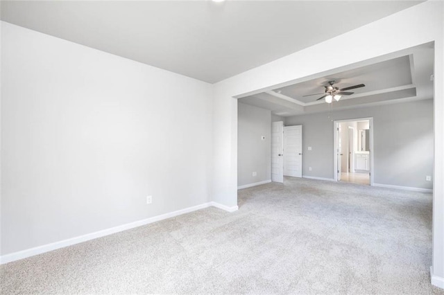 113 Canal St, Hampton, GA 30228 - empty room with a tray ceiling, baseboards, a ceiling fan, and light colored carpet