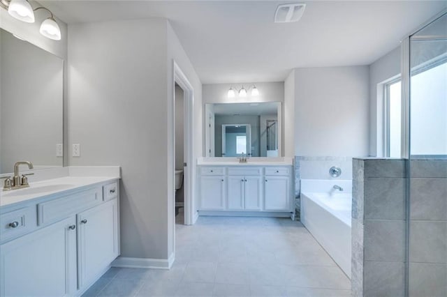 113 Canal St, Hampton, GA 30228 - full bath with two vanities, a bath, toilet, tile patterned flooring, and baseboards