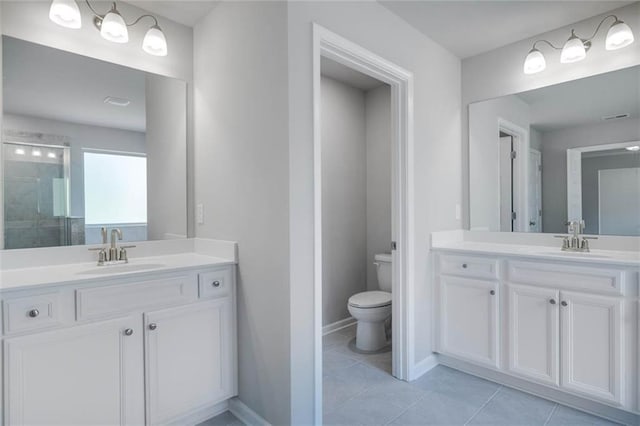 113 Canal St, Hampton, GA 30228 - bathroom with toilet, two vanities, tile patterned flooring, and tiled shower