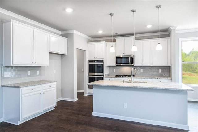 113 Canal St, Hampton, GA 30228 - kitchen featuring appliances with stainless steel finishes, a sink, crown molding, backsplash, and white cabinetry