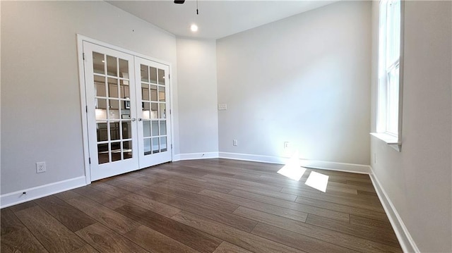 spare room featuring dark hardwood / wood-style floors, ceiling fan, and french doors