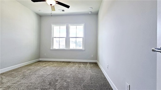 carpeted spare room featuring ceiling fan