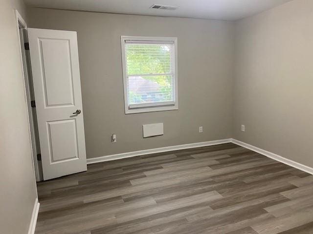 empty room with dark wood-type flooring