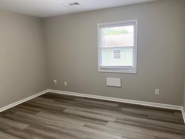 unfurnished room featuring dark wood-type flooring