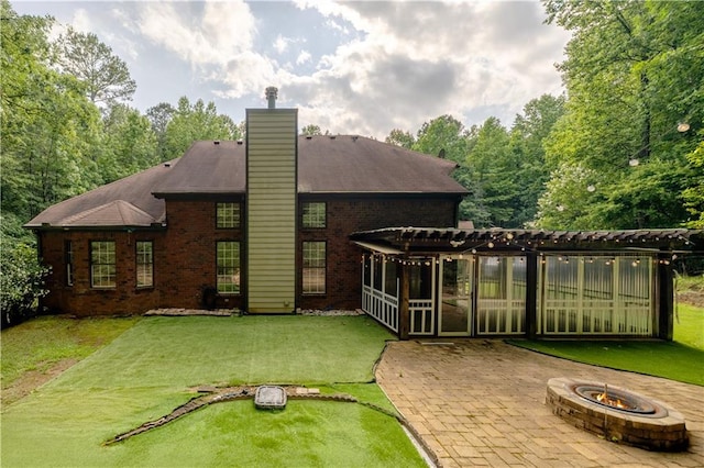 540 Branch Dr, Pendergrass, GA 30567 - rear view of property featuring a pergola, a fire pit, a patio, brick siding, and a chimney