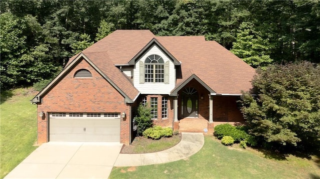 540 Branch Dr, Pendergrass, GA 30567 - traditional-style house featuring concrete driveway, brick siding, a front yard, and an attached garage