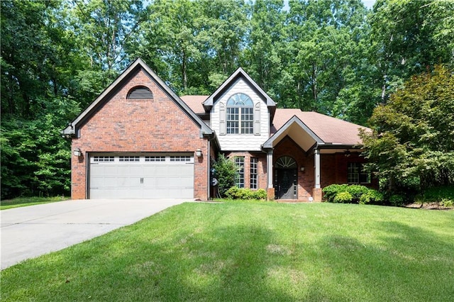 540 Branch Dr, Pendergrass, GA 30567 - traditional-style home featuring brick siding, a front lawn, driveway, a garage, and view of wooded area