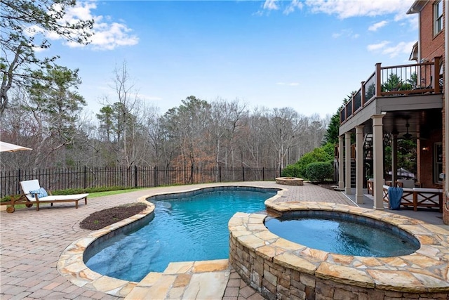 view of swimming pool featuring a fenced backyard, a fenced in pool, an in ground hot tub, and a patio