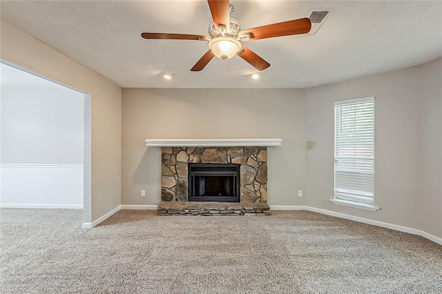 unfurnished living room featuring carpet, a fireplace, and baseboards