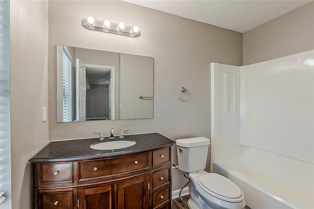 full bath featuring toilet, vanity, and shower / bathtub combination