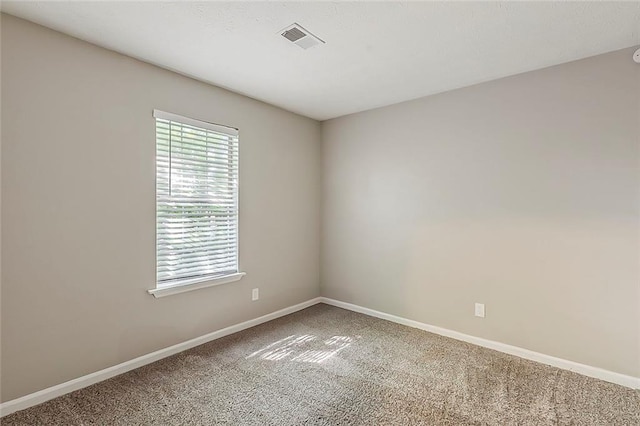 unfurnished room featuring carpet and baseboards