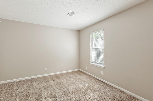 unfurnished room with baseboards and light carpet