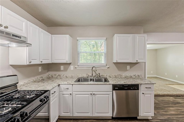 kitchen featuring black gas stove, stainless steel dishwasher, a sink, under cabinet range hood, and white cabinets