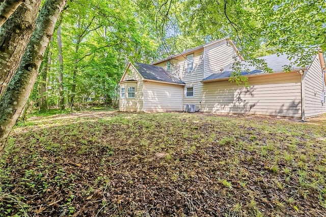 5786 Longbow Dr, Stone Mountain, GA 30087 - back of house featuring central air condition unit and an outdoor structure