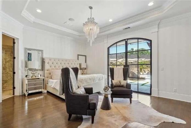 bedroom featuring a raised ceiling, wood finished floors, access to outside, a chandelier, and ornamental molding