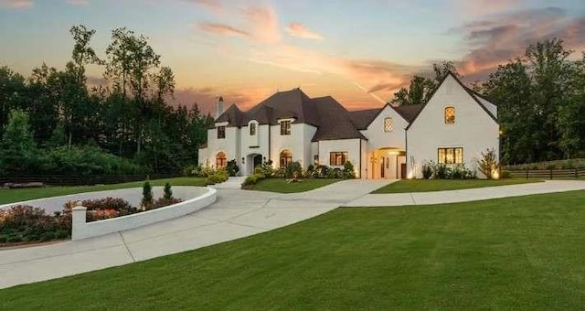 french country style house featuring stucco siding