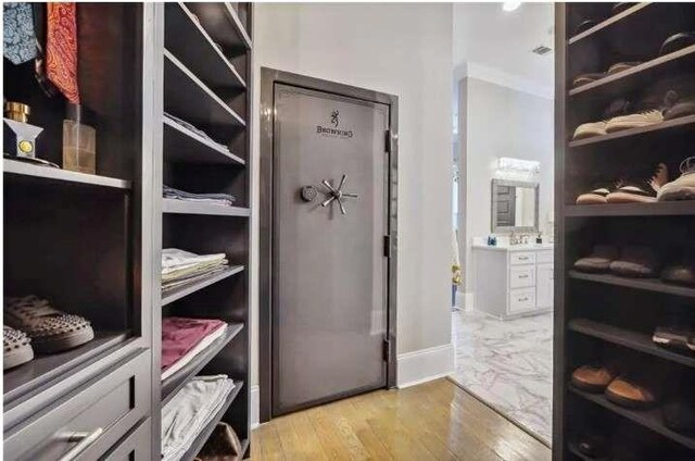 spacious closet featuring light wood-style flooring