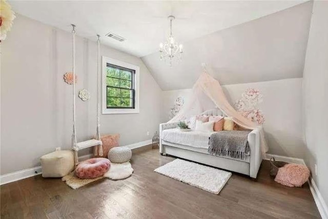 bedroom with lofted ceiling, a chandelier, wood finished floors, and baseboards