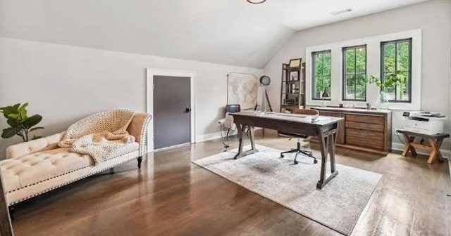 office space with lofted ceiling, light wood-style flooring, and baseboards