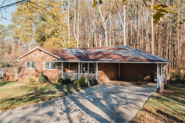 ranch-style house with covered porch, a front lawn, and a carport