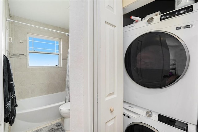 laundry room with stacked washer / drying machine