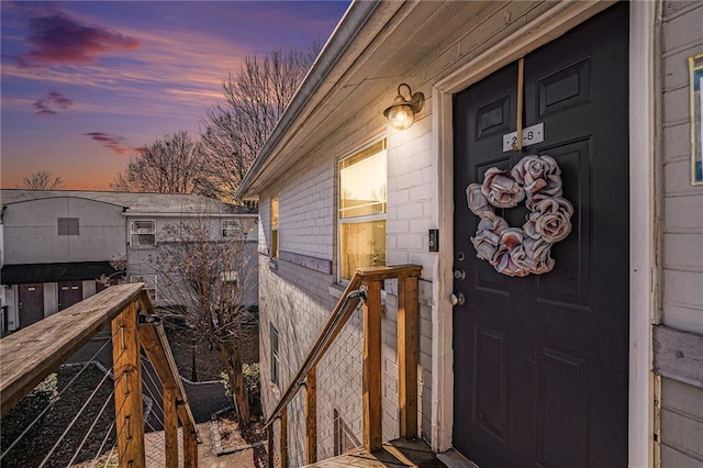 view of exterior entry at dusk