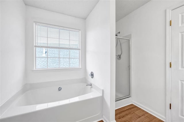 bathroom featuring hardwood / wood-style floors and independent shower and bath