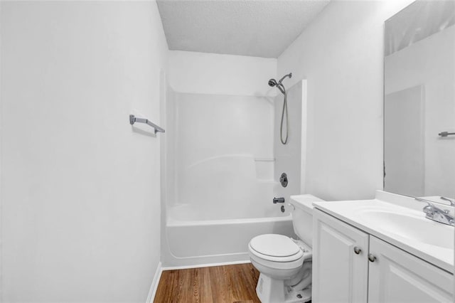 full bathroom with vanity, a textured ceiling, wood-type flooring, shower / tub combination, and toilet