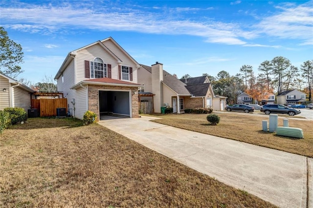 view of front of property featuring a front yard, central AC unit, and a garage