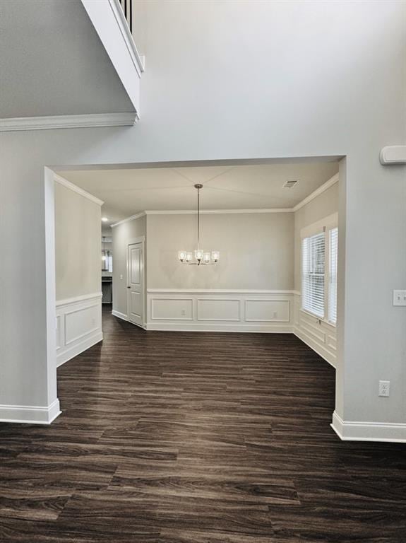59 Observation Ct, Dallas, GA 30132 - unfurnished dining area featuring ornamental molding, a chandelier, dark wood-style floors, a decorative wall, and wainscoting