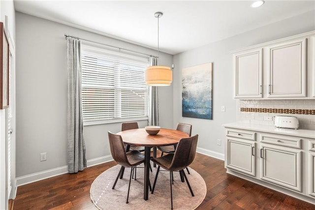 dining area with dark wood-style flooring, recessed lighting, and baseboards