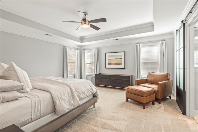 bedroom with light carpet, visible vents, a raised ceiling, ceiling fan, and crown molding