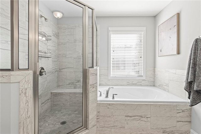 full bath featuring a garden tub and a shower stall