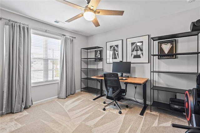 carpeted office with a ceiling fan, visible vents, and baseboards