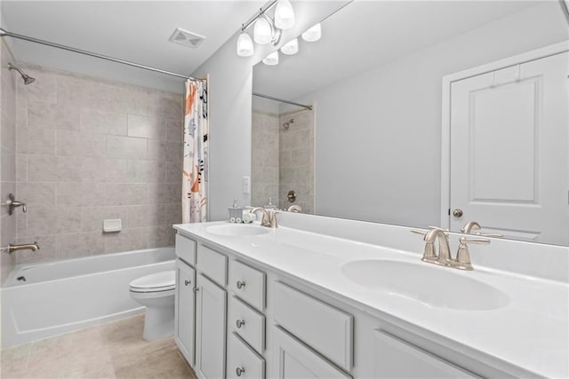 bathroom featuring toilet, shower / tub combo, visible vents, and a sink