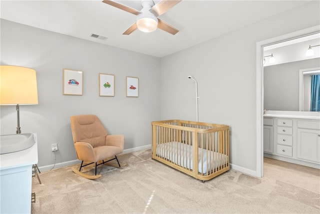 bedroom with a nursery area, baseboards, visible vents, and light colored carpet