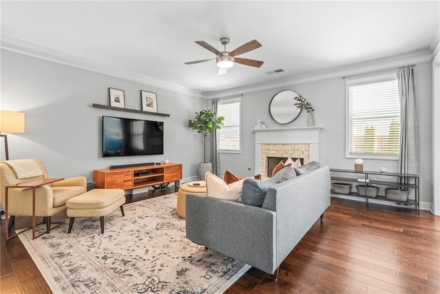 living area featuring visible vents, dark wood finished floors, and crown molding