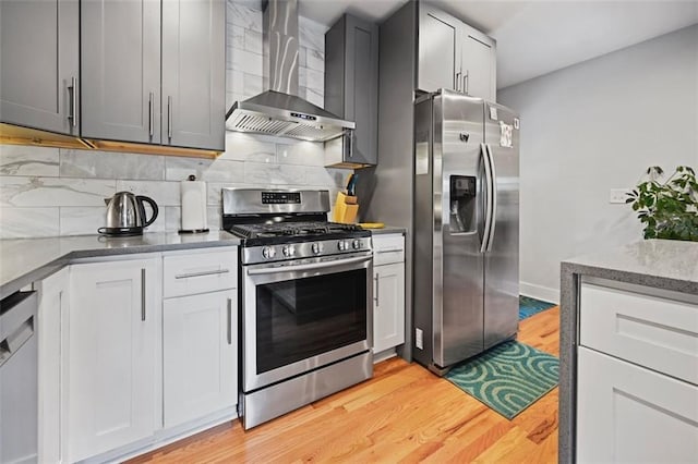 670 Parker Ave, Decatur, GA 30032 - kitchen with appliances with stainless steel finishes, wall chimney exhaust hood, light wood-style flooring, backsplash, and stone countertops