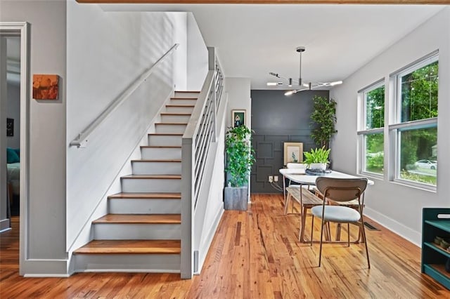 670 Parker Ave, Decatur, GA 30032 - staircase with wood finished floors, baseboards, and a chandelier