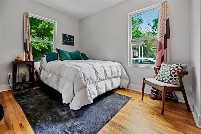 670 Parker Ave, Decatur, GA 30032 - bedroom with multiple windows, wood finished floors, and baseboards