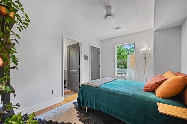 670 Parker Ave, Decatur, GA 30032 - bedroom with wood finished floors, baseboards, ensuite bathroom, and a ceiling fan
