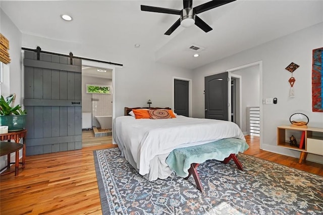 670 Parker Ave, Decatur, GA 30032 - bedroom with light wood finished floors, a barn door, recessed lighting, and ceiling fan