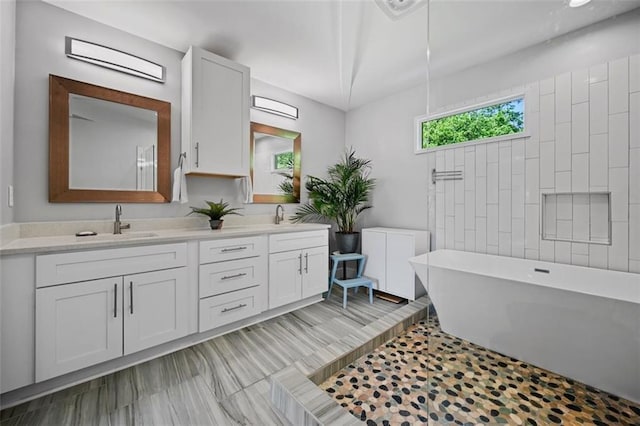 670 Parker Ave, Decatur, GA 30032 - bathroom with a freestanding bath and double vanity